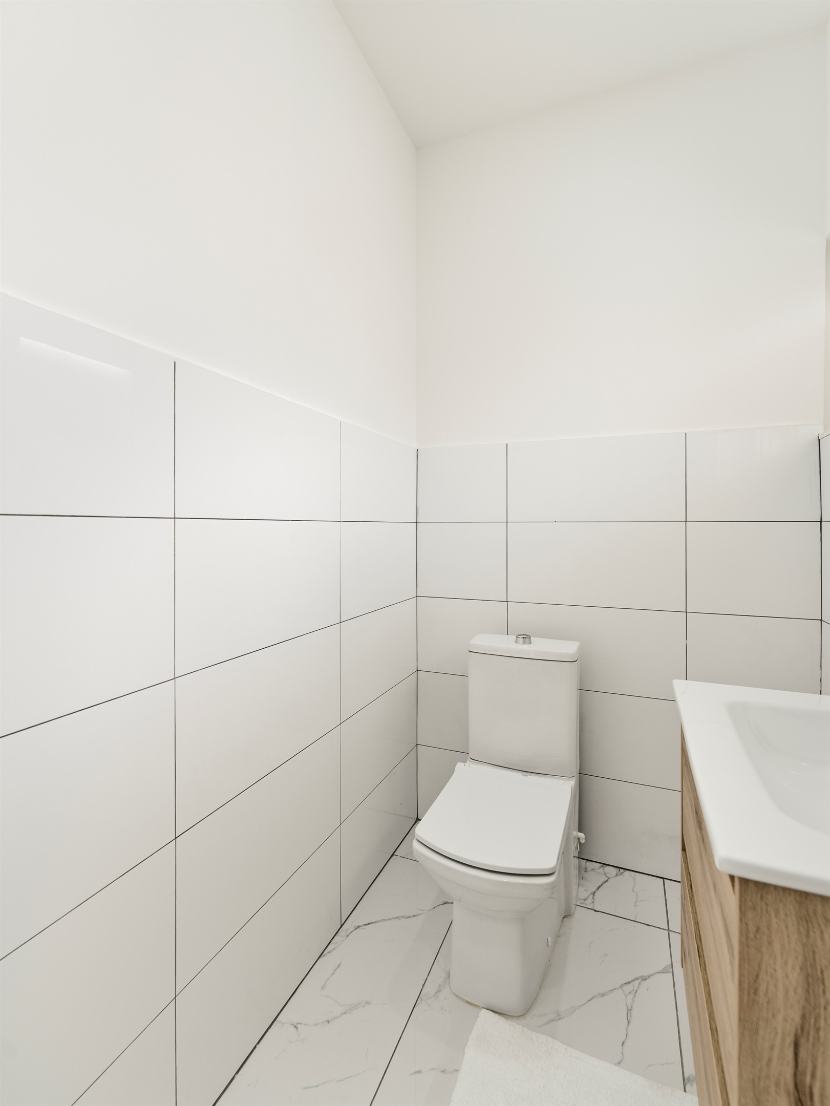 Minimalist Half Bath with Contemporary Toilet & Bright White Tile