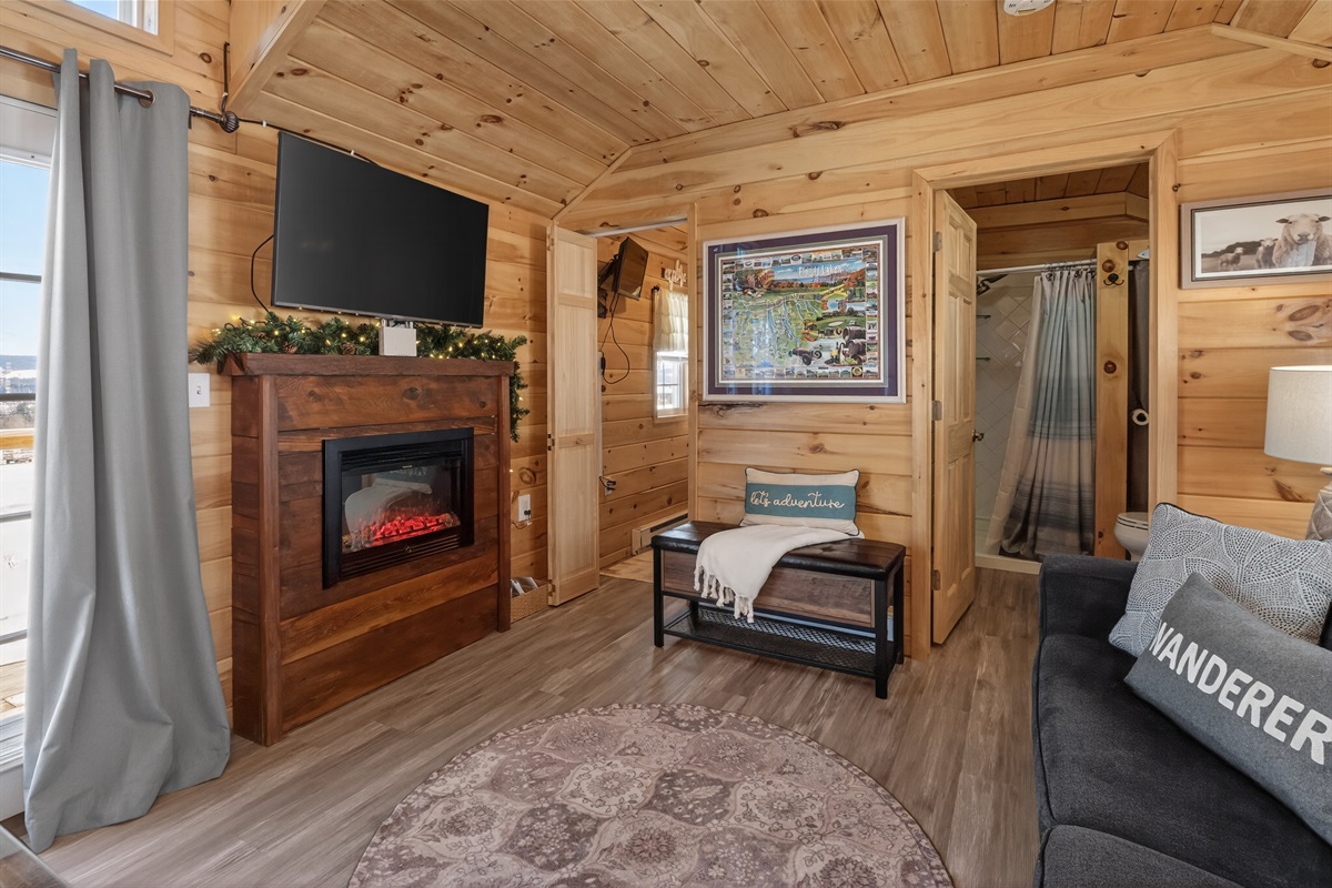 Tiny house living room with bathroom and bunk room entry