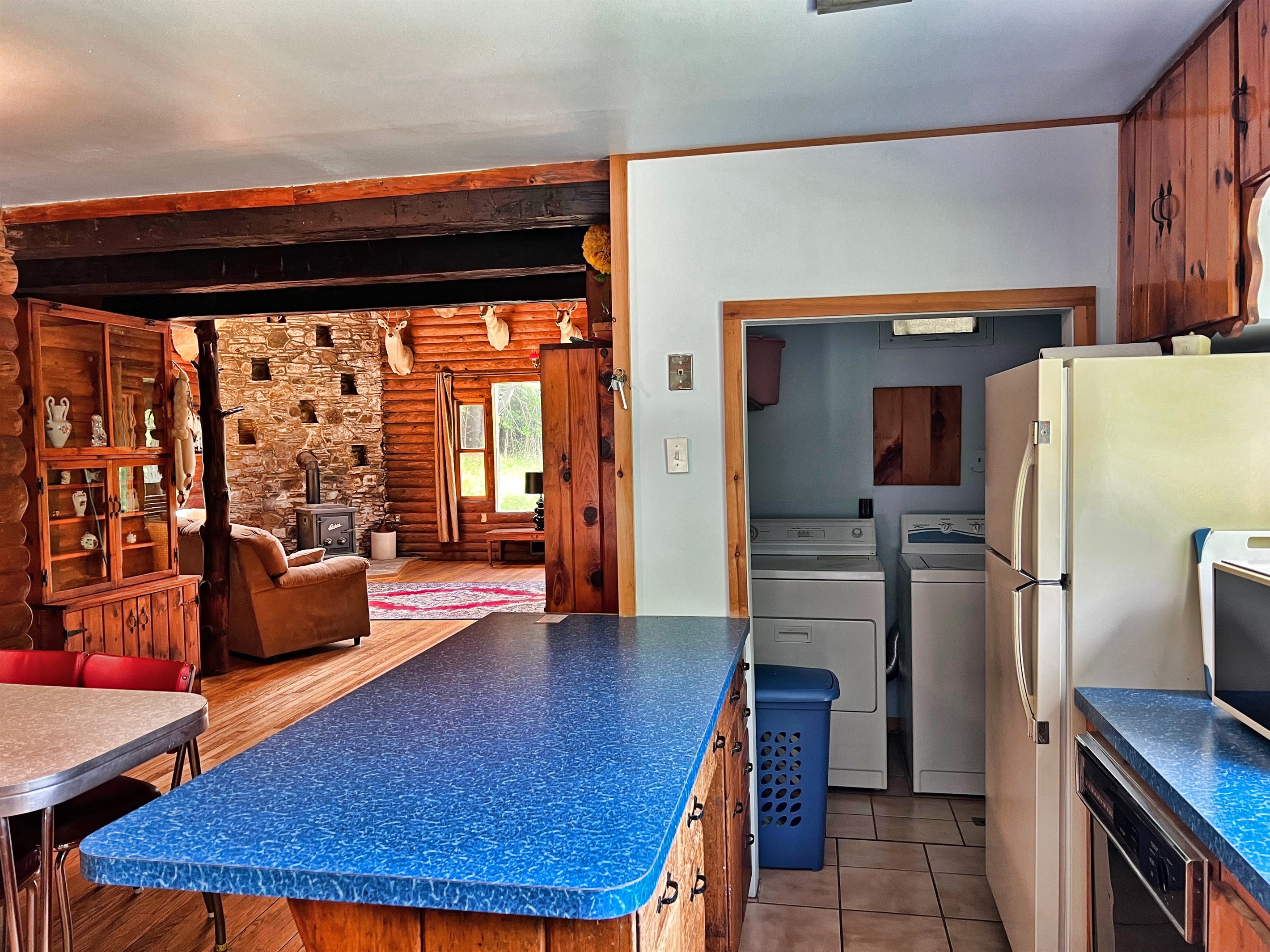 View into the living room from the kitchen. The laundry area is conveniently located just off the kitchen.
