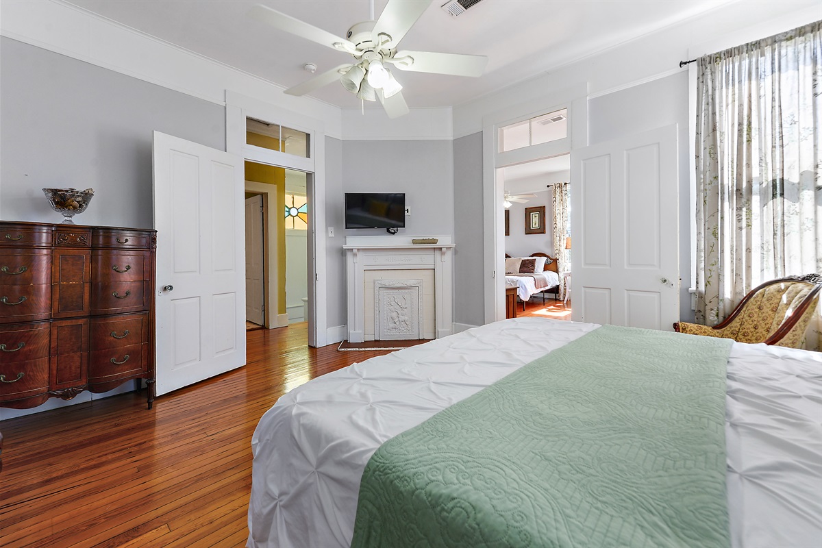 Bedroom 4. Upstairs. King bed. Smart tv.  Looking into bedroom 3.