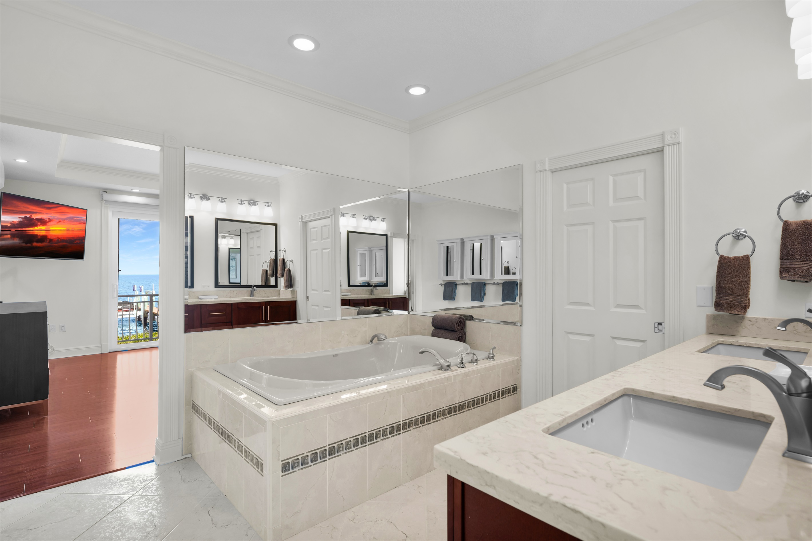 Primary ensuite bathroom with jetted tub, toilet/bidet room with shower and walk in closet