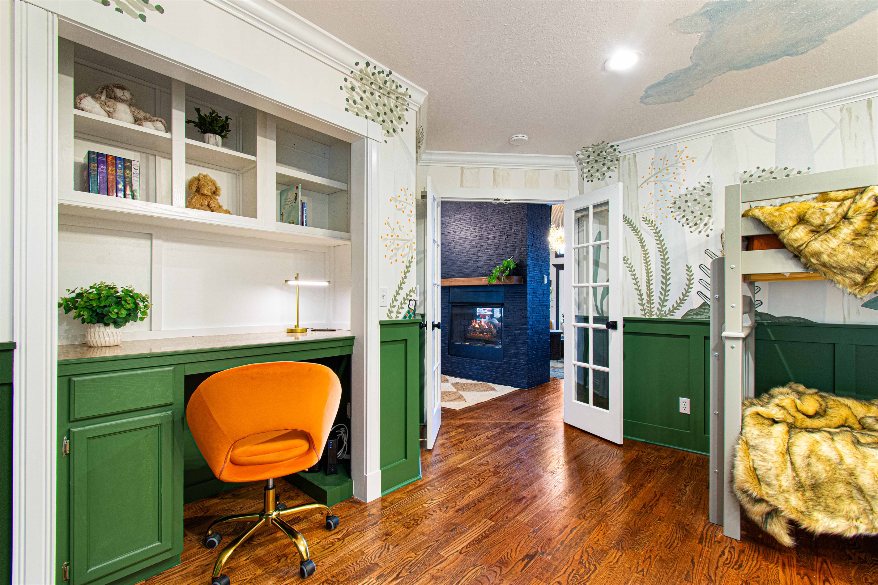 This cozy nook in the bunk room is perfect for reading or getting some quiet time. The playful decor and thoughtful design make it a delightful space for both work and relaxation.
