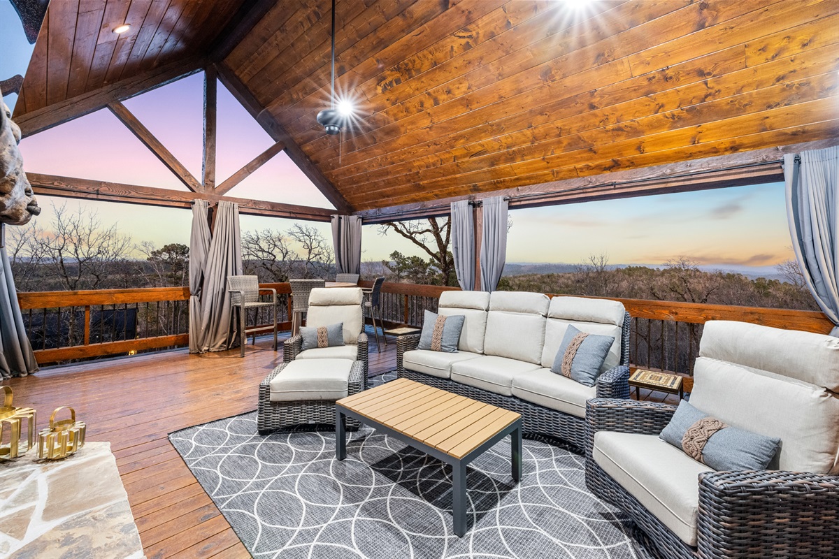 Spacious covered outdoor lounge with breathtaking sunset and mountain views
