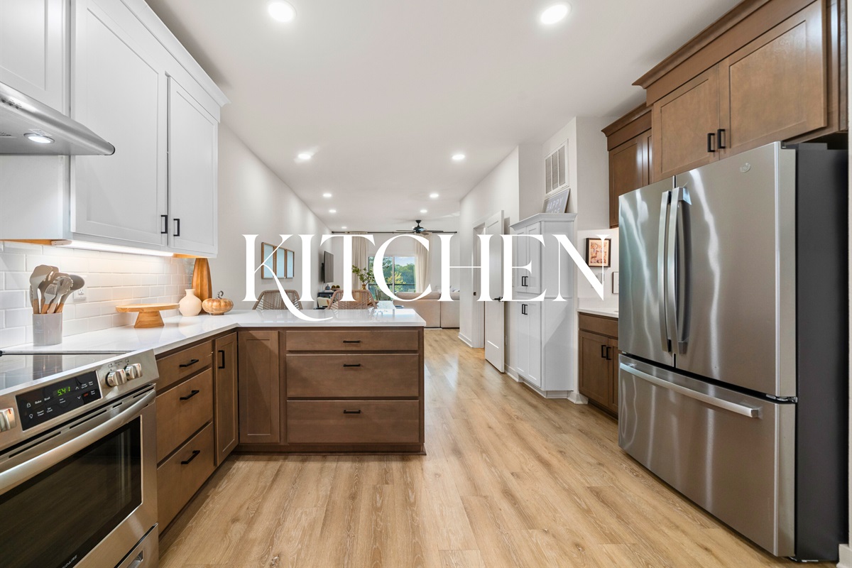 Modern kitchen fully equipped with stainless steel appliances and spacious countertops for effortless cooking.