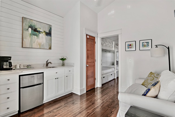 3rd floor sitting area features a wet bar with sink and mini fridge and opens to the large 3rd floor porch that overlooks the neighborhood