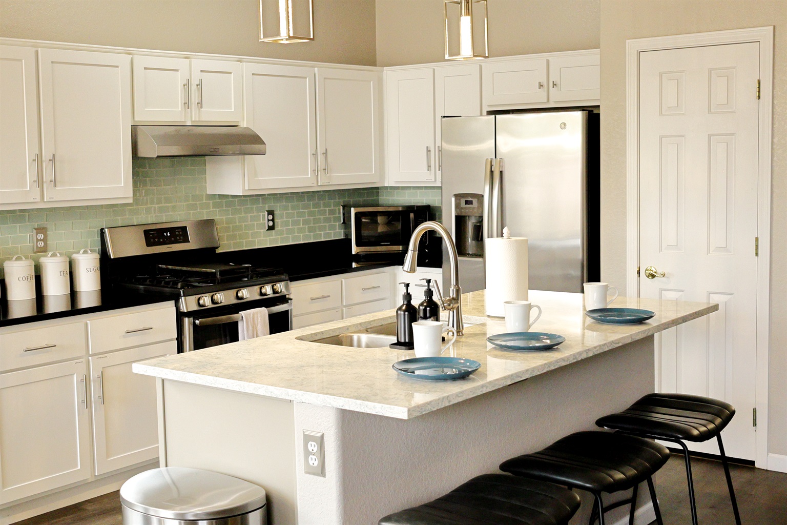 Bright, open kitchen with full amenities and modern lighting — ideal for family cooking and entertaining. 