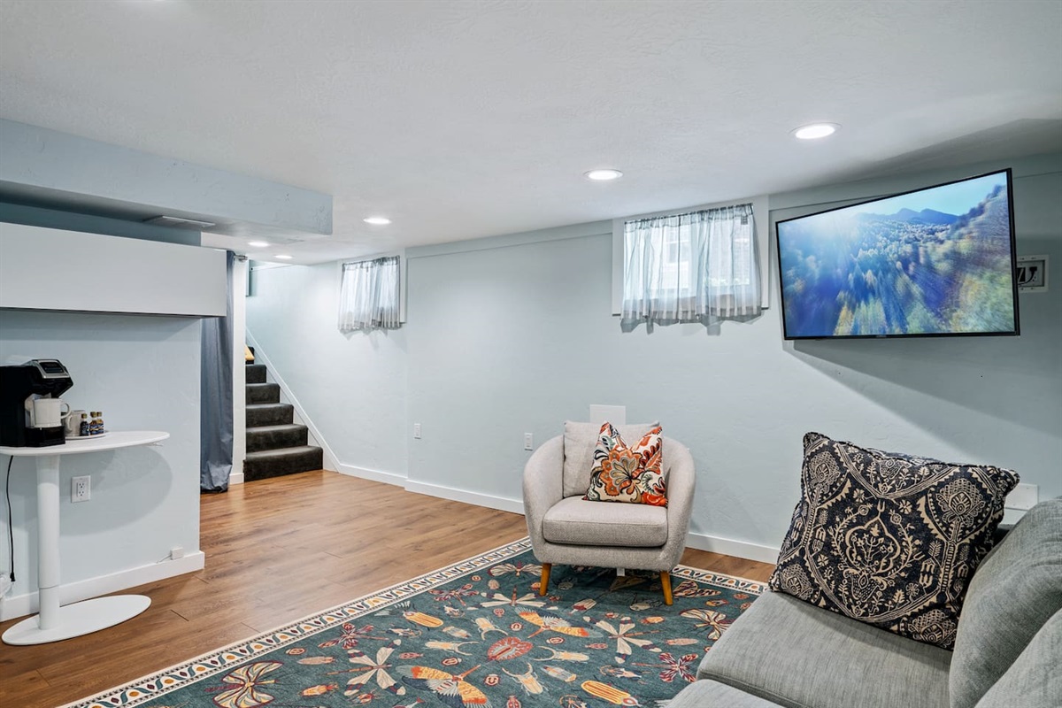 Downstairs living room offers coffee bar and large TV