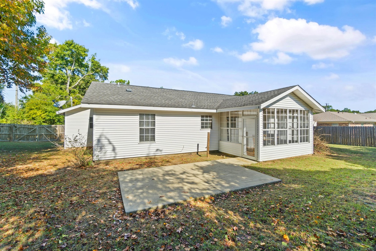 Step out into this spacious, fully fenced backyard—ideal for pets, kids, or simply relaxing in the fresh air. The concrete patio area provides the perfect spot for a grill or outdoor seating.