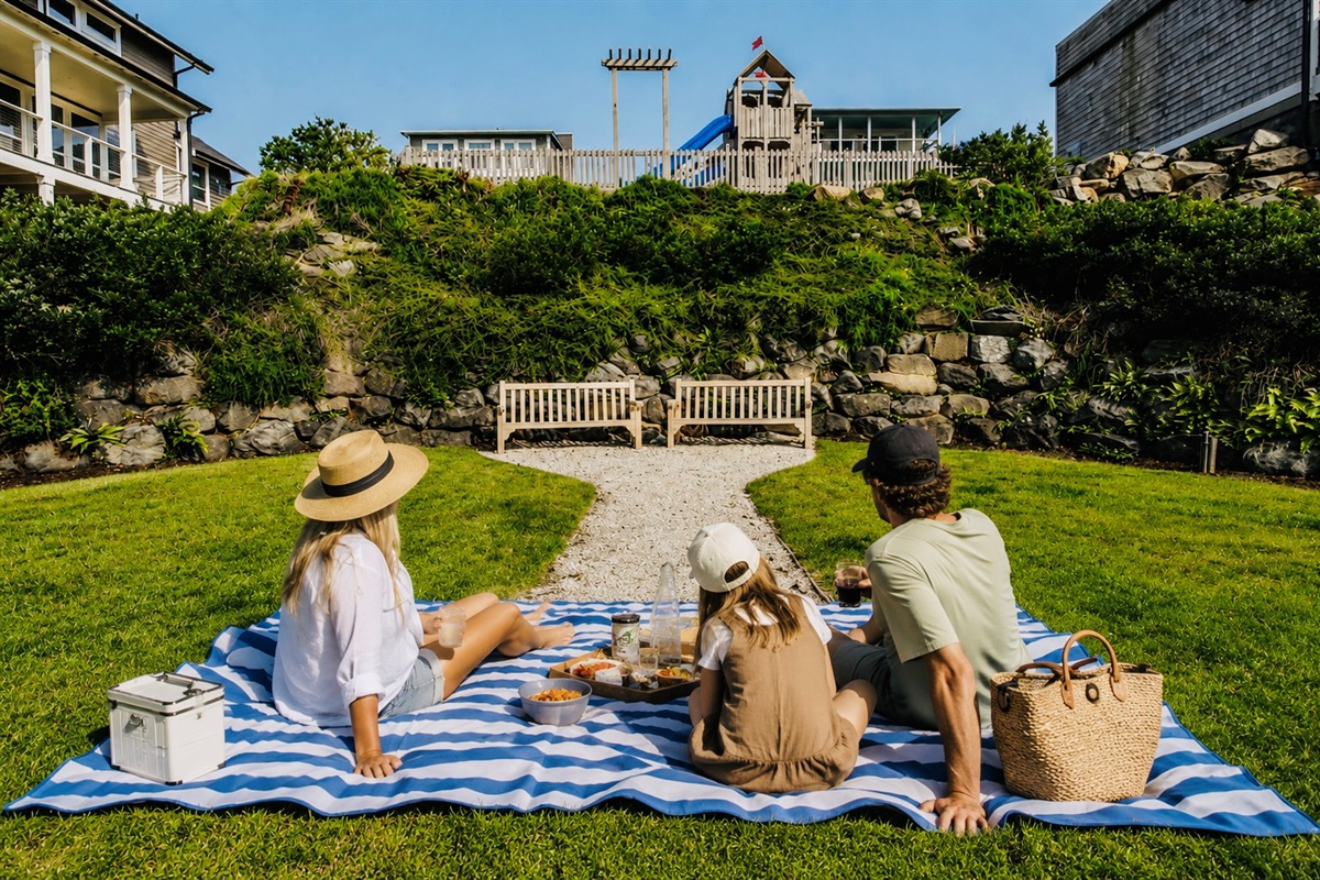 Beautiful shared green space and seating area located right next to home- perfect for reading, picnicking, or enjoying the ocean breeze. 