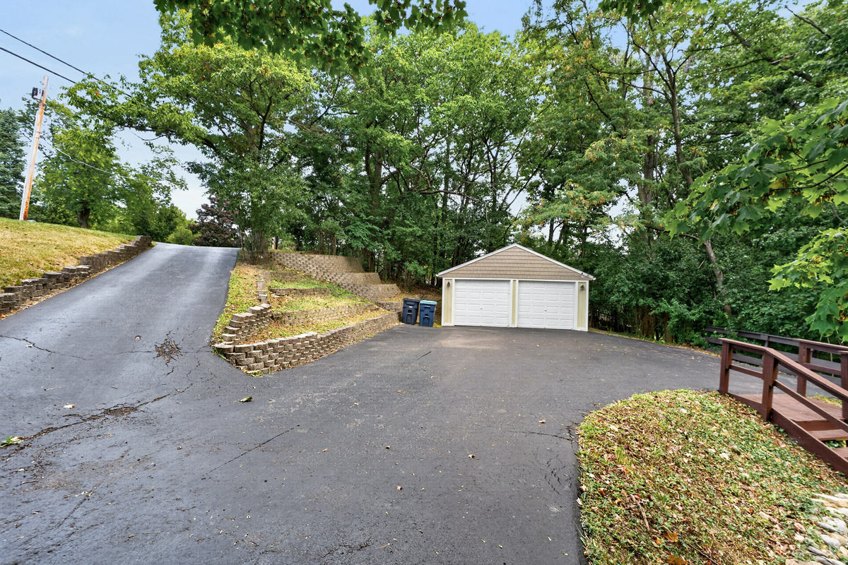 Paved driveway leading to detached garage