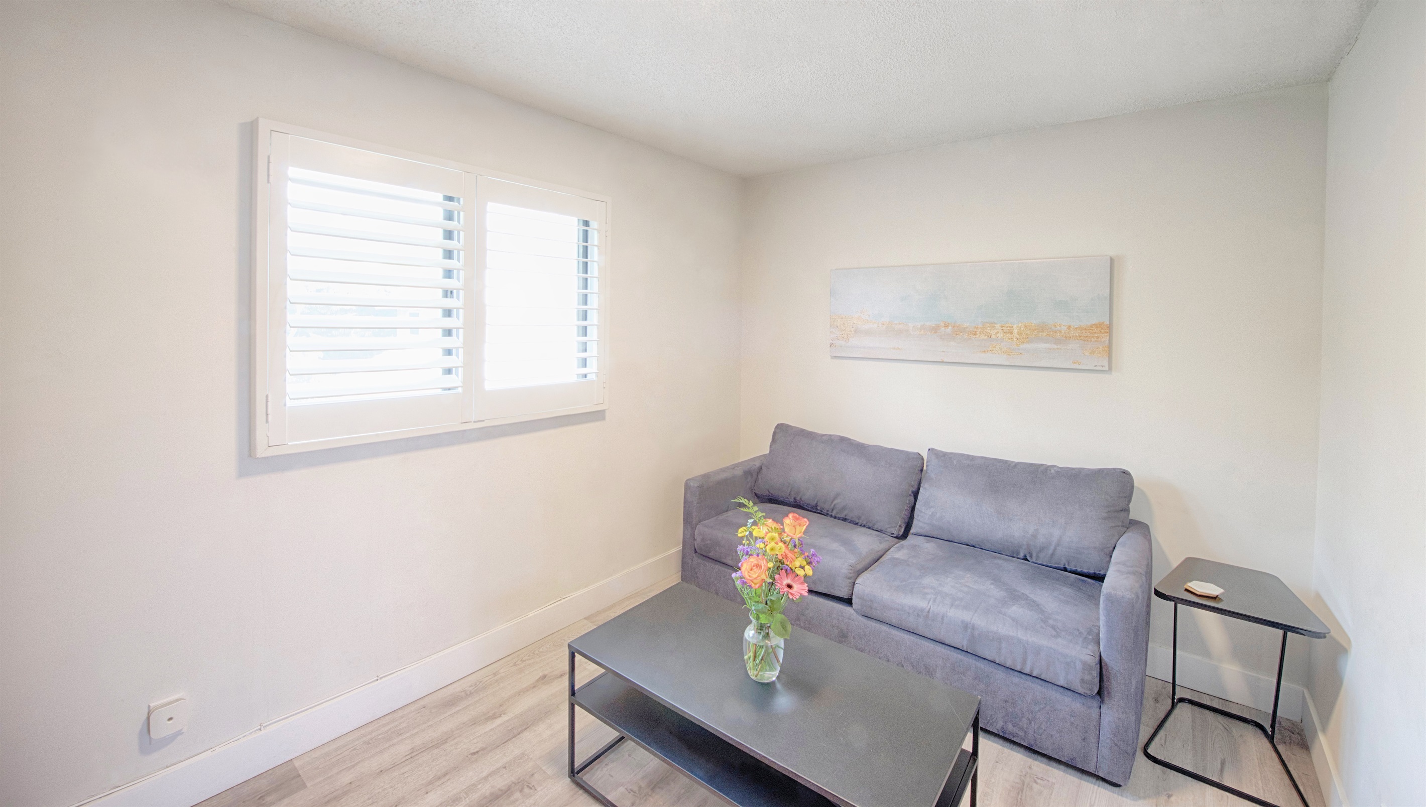 Family room includes sofa with pull out queen bed and coffee table. Sleeps two guests.