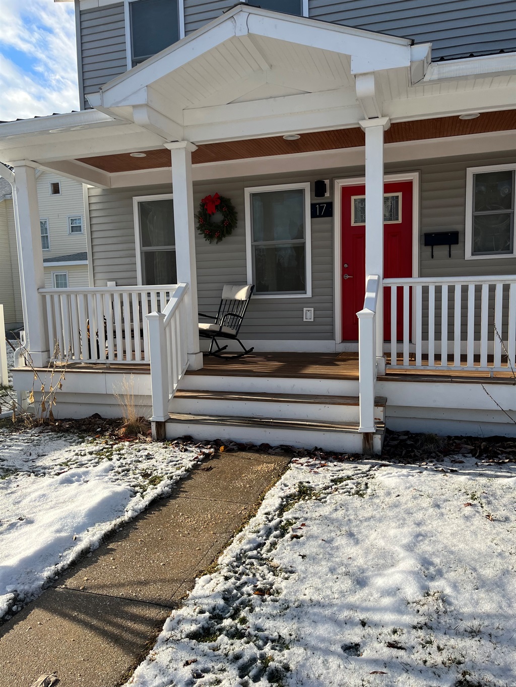 A bright red door and a rocking chair waiting just for you. Come for the charm, stay for the morning coffee with a view