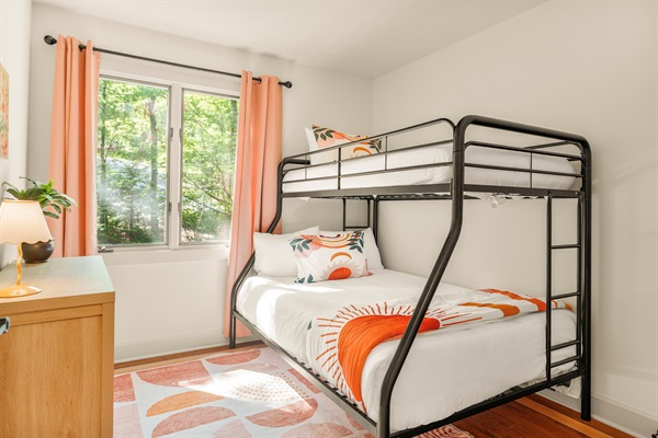Upstairs twin over full bunk bedroom with hanging closet and dresser. 