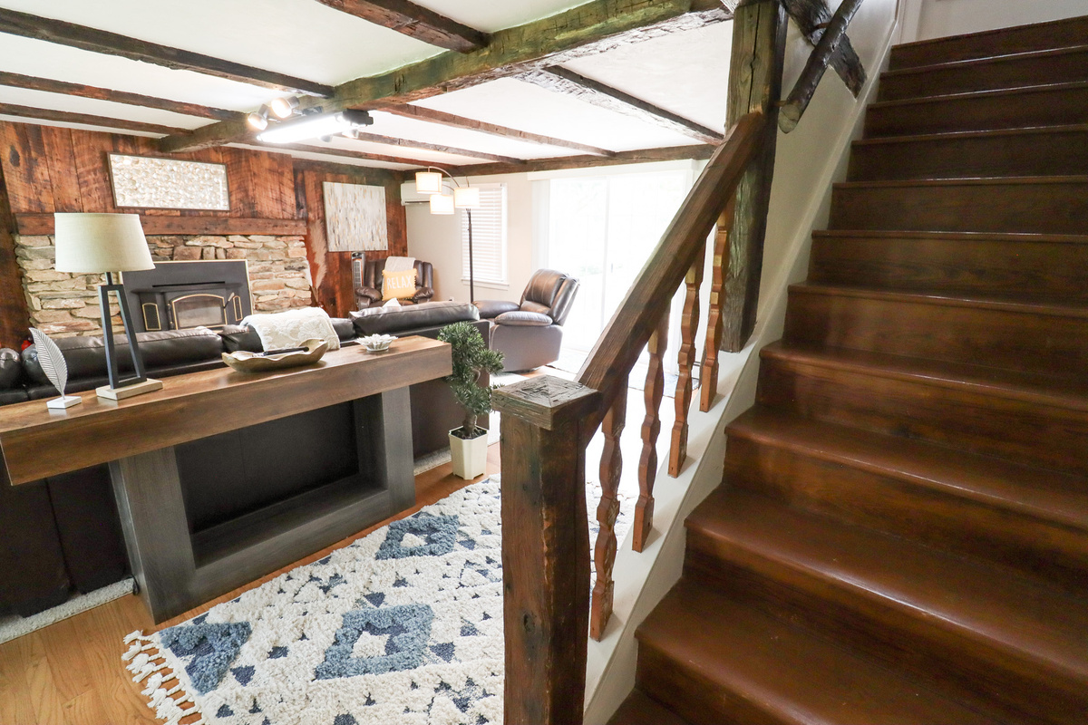 Warm, rustic staircase leads to comfortable accommodations, blending historic charm with modern amenities