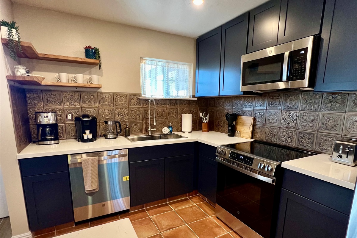 Whip up a meal in the fully-equipped modern kitchen, featuring stainless steel appliances and a stylish breakfast bar with seating for two.