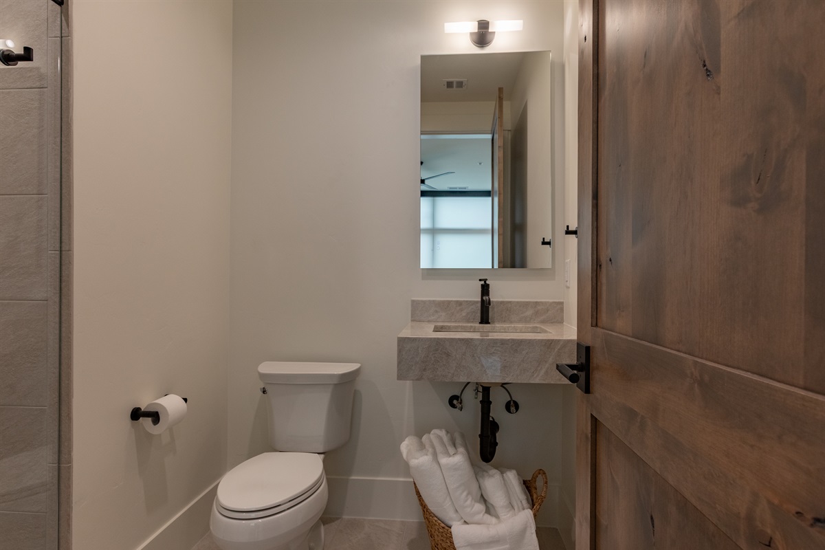Middle Teton - Stylish private ensuite with a walk-in shower and rich wood accents.
