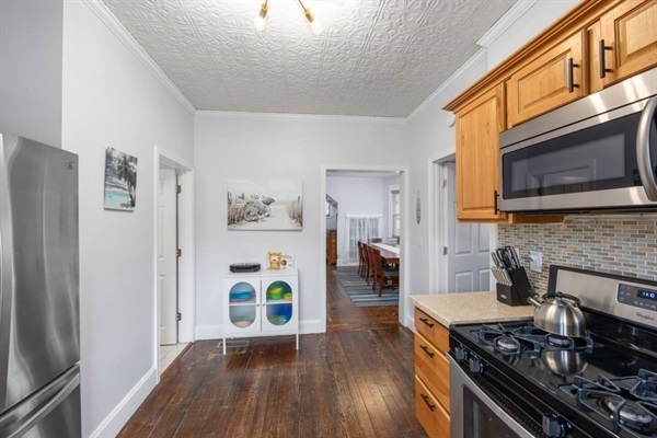 Laundry room with side by side washer and dryer, and shelf full of towels