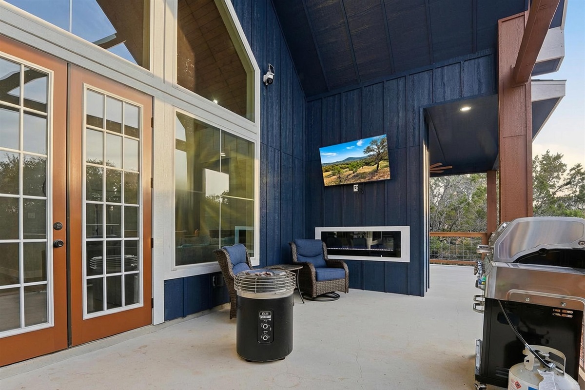 Covered outdoor living with BBQ, TV, and multiple seating zones for relaxed evenings together