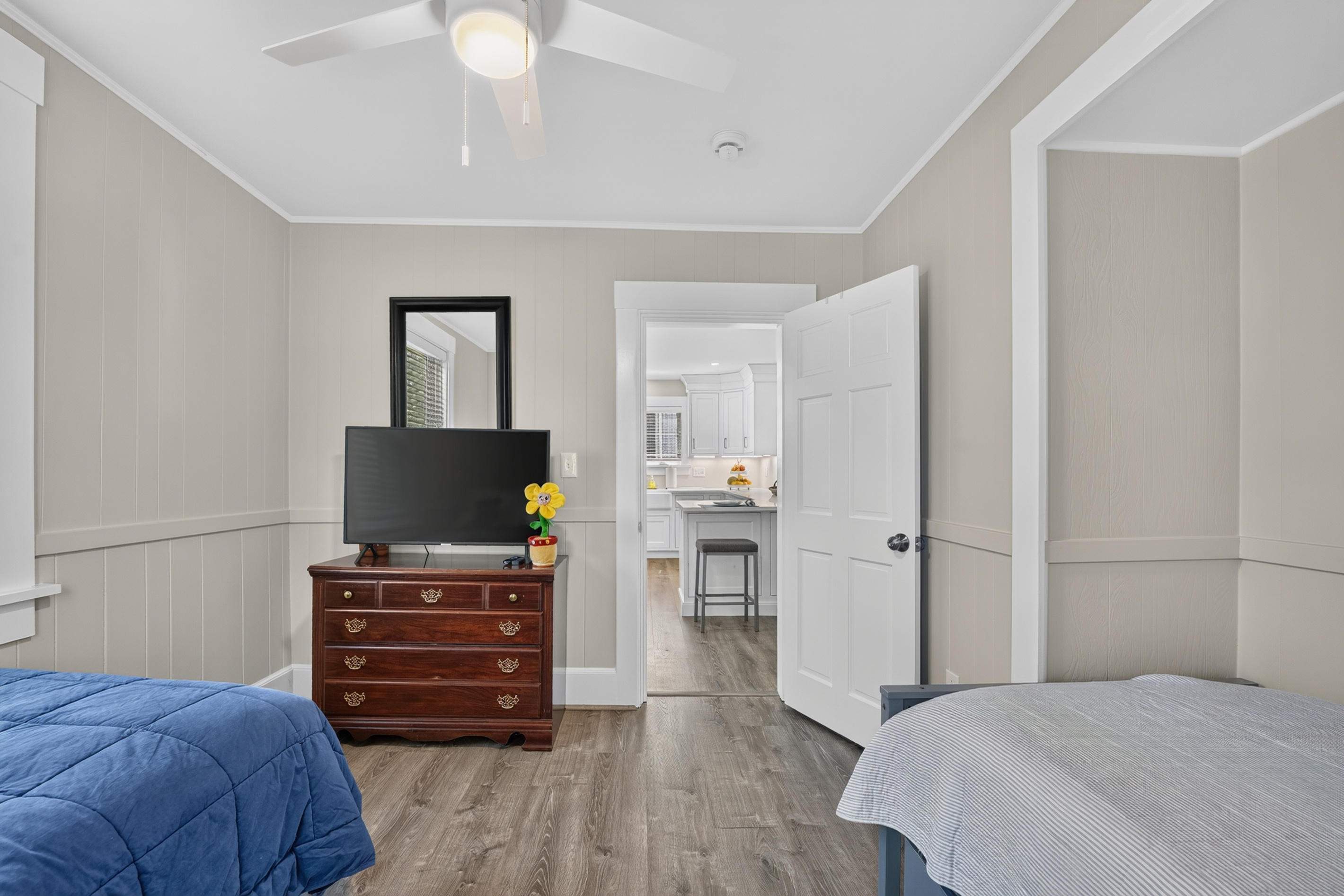 Flexible sleeping arrangements with twin beds, dresser storage, and easy access to the adjoining rooms.