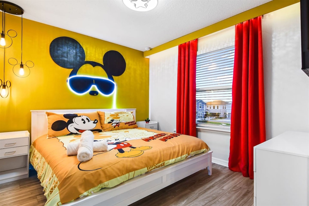 Mickey Mouse magic awaits in this themed king bedroom, featuring an en suite bathroom with a stand-up shower and a smart TV.