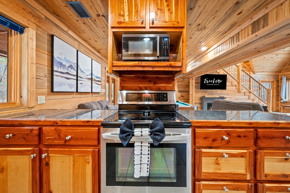 Rustic cabinetry paired with modern appliances blends cabin character with everyday convenience.