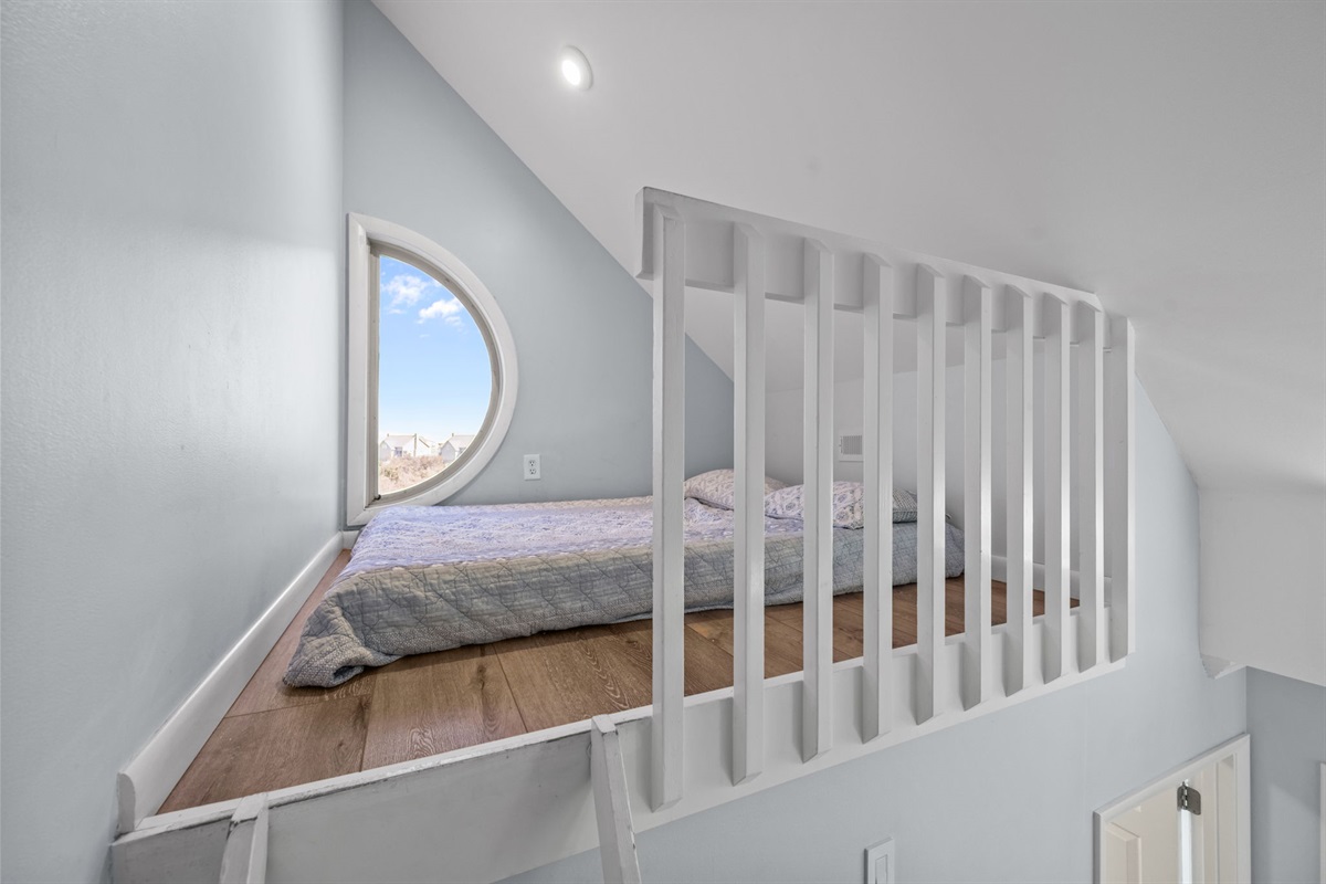 Cozy loft retreat with a full mattress, perfect for extra guests or a quiet reading nook.