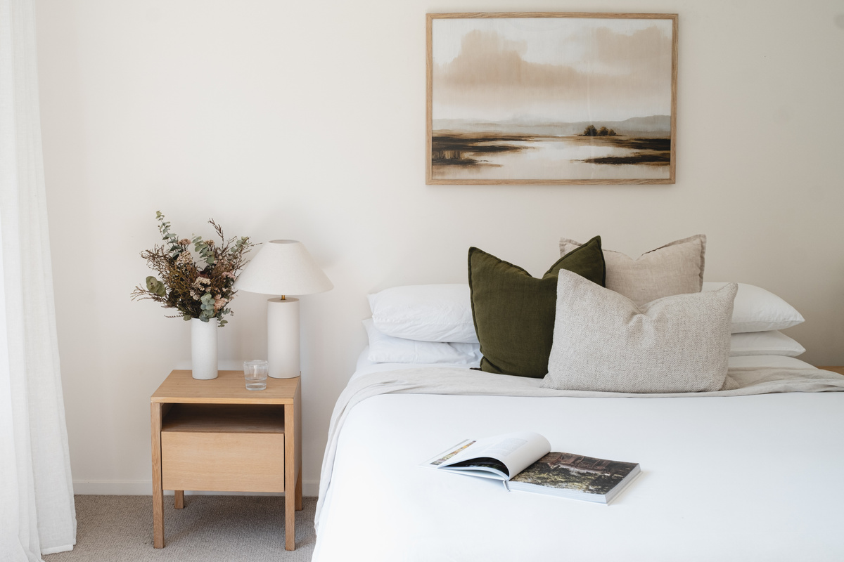 Beautifully styled bedroom with plush bedding, calming neutral tones and thoughtful details for a comfortable, relaxing stay.