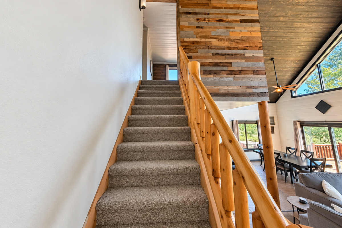The upstairs is conveniently accessed just off the main living room, making it easy to move between the shared gathering space and upper-level bedrooms.