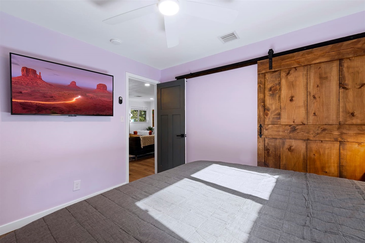 A king size bed in the lilac room, also with custom barn slider doors for the closet.