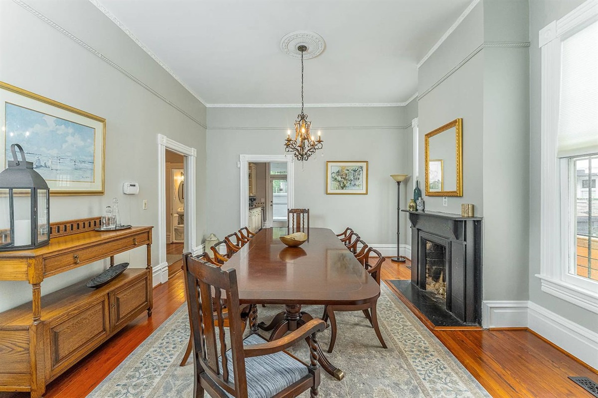 Entertain family and friends in the dining room with towering 11+ foot ceilings.  The long dining room table is perfect for gathering together and making lasting Savannah memories.