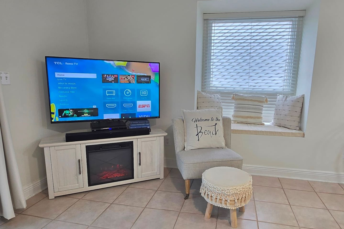 Flip on the electric fireplace, claim your corner of the couch, and let the evening stretch out &mdash; the living room pulls the whole group in.