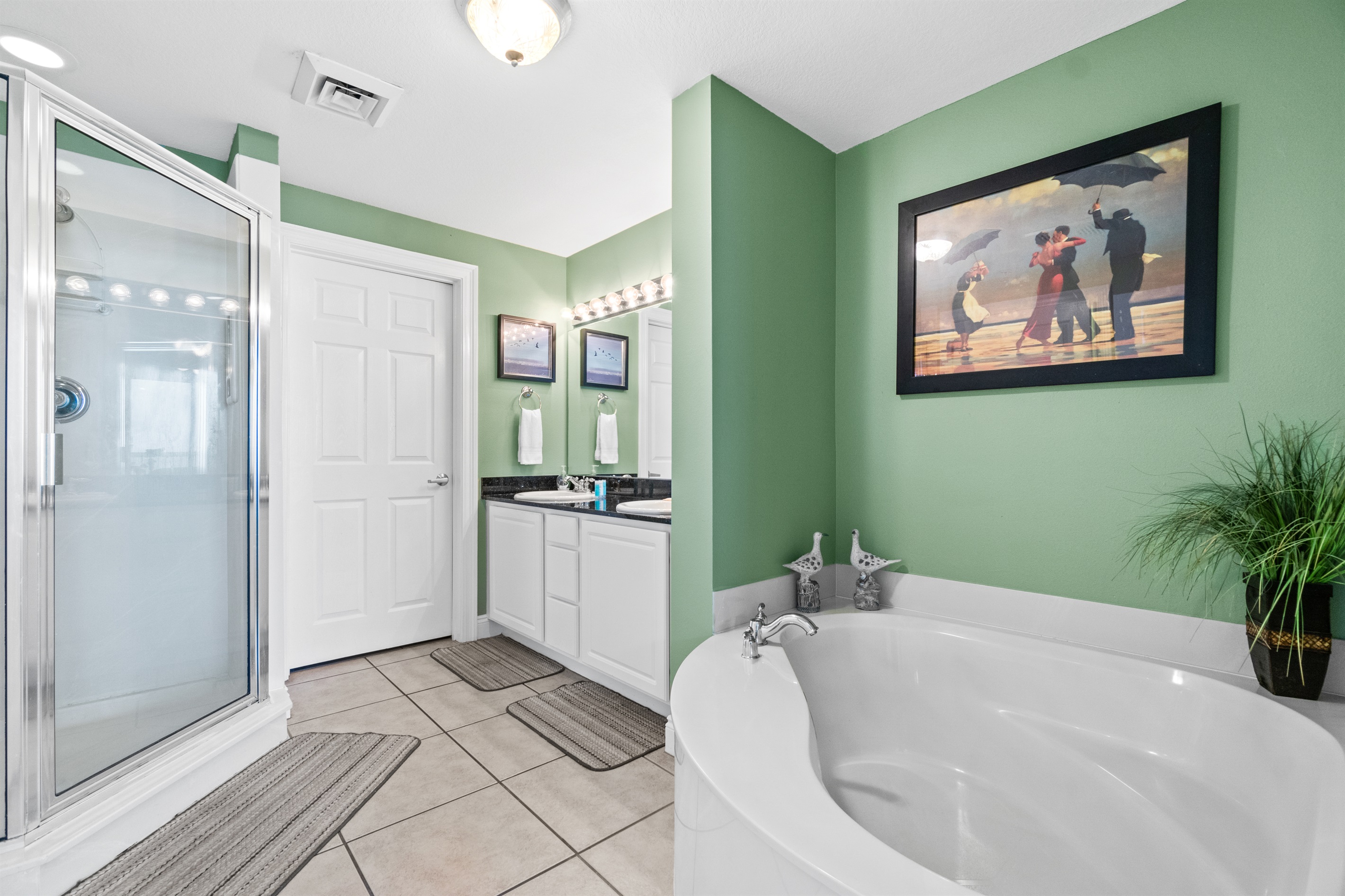 Master bathroom, huge jetted garden tub, walk in shower, huge walk in closet behind the closed door