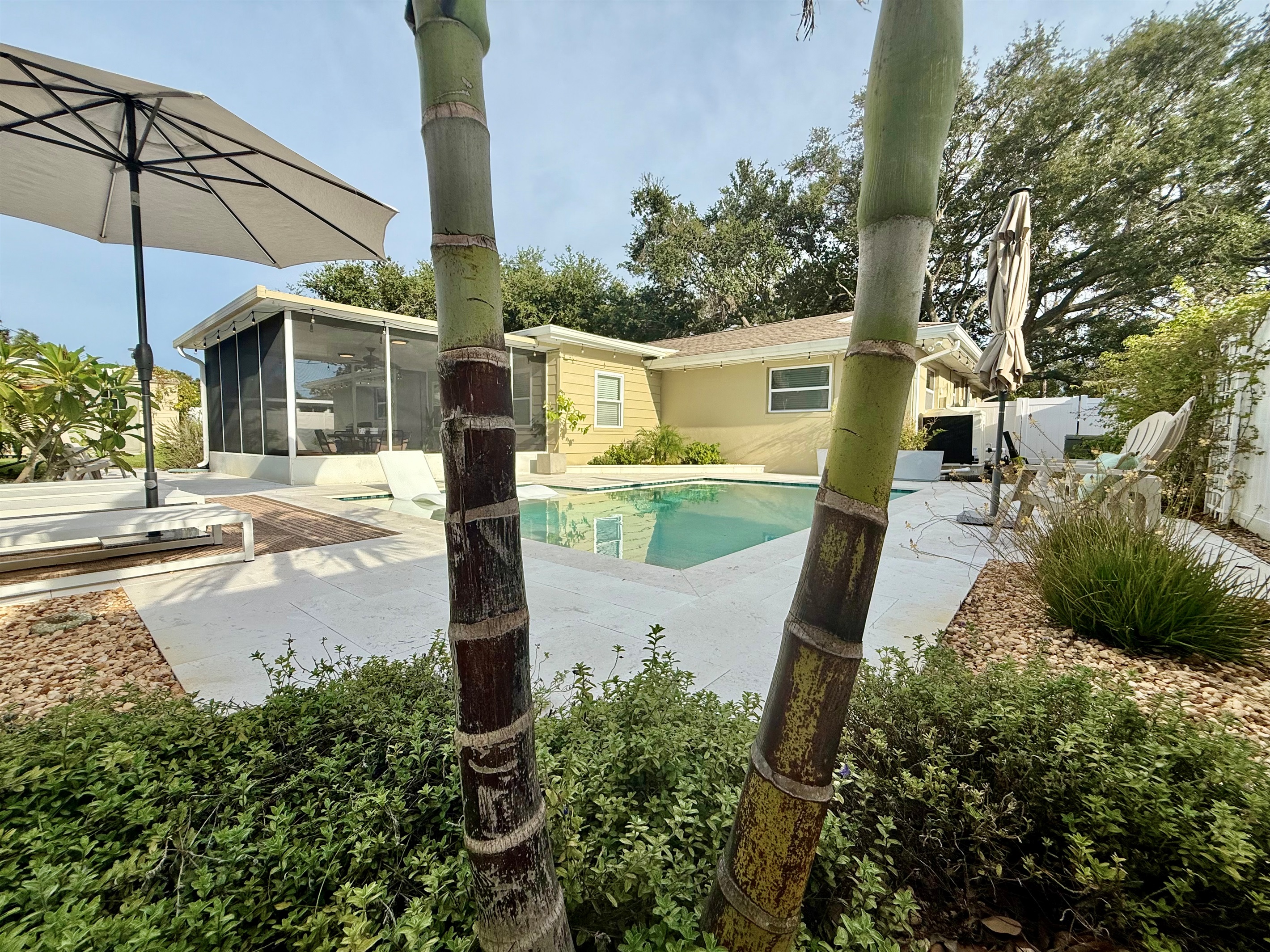 Enjoy breezy mornings or relaxing evenings in this spacious screened-in patio overlooking the pool.