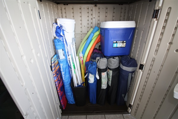 Beach chairs, umbrella's, and a rolling cooler for your use.