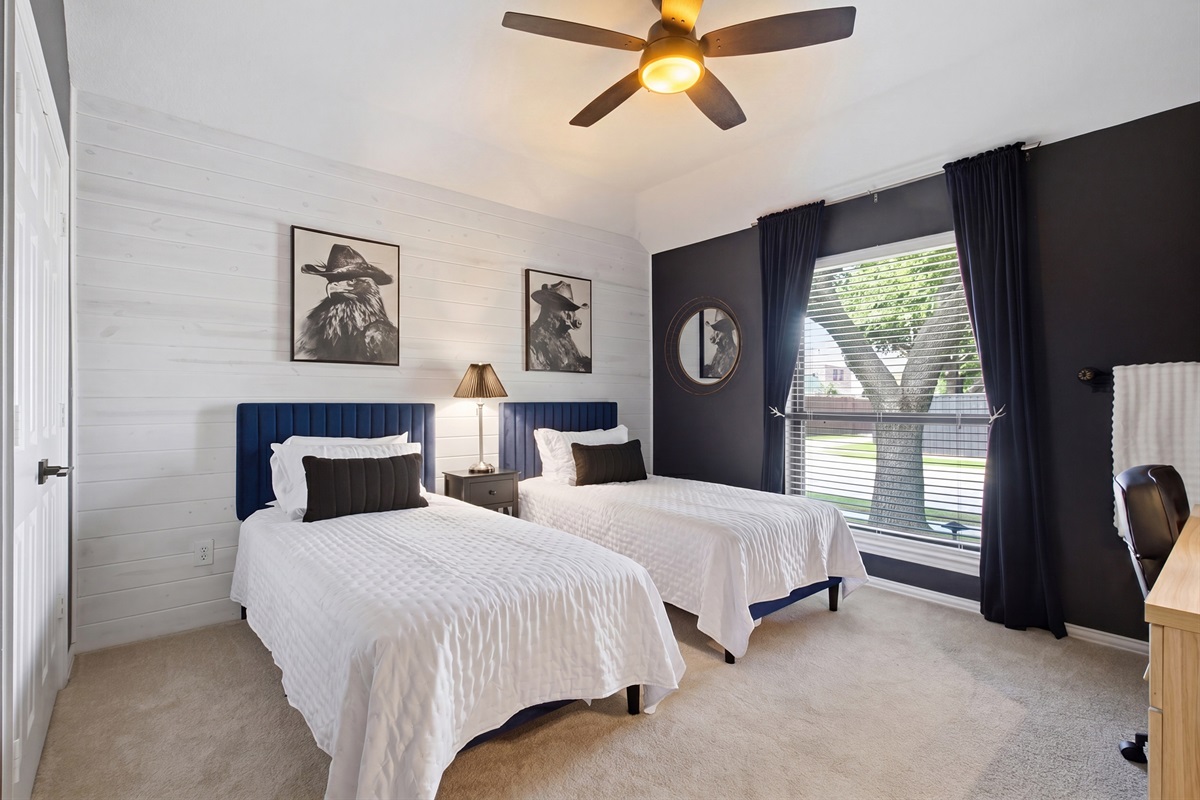 Guest Bedroom 3 with 2 Twin Beds, navy and white accents, and Western-inspired art. Sleeps two and works perfectly for kids or solo travelers.
