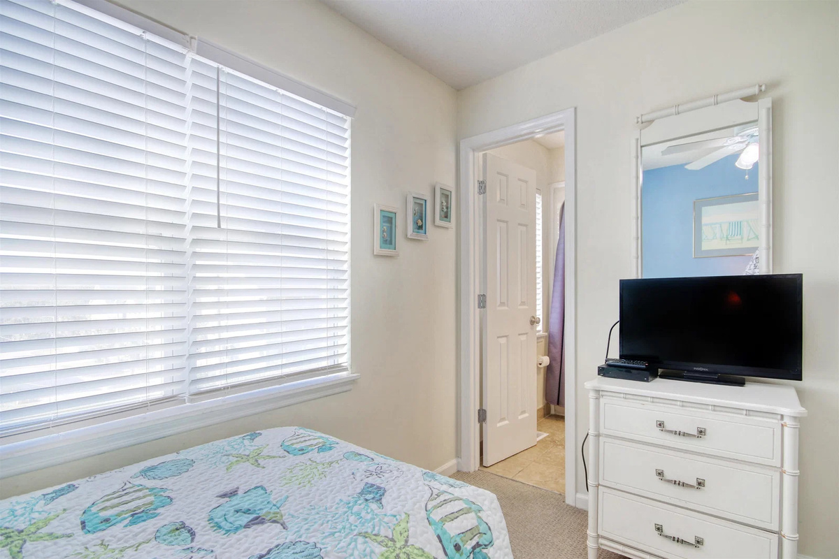 Guest bedroom with TV and dresser