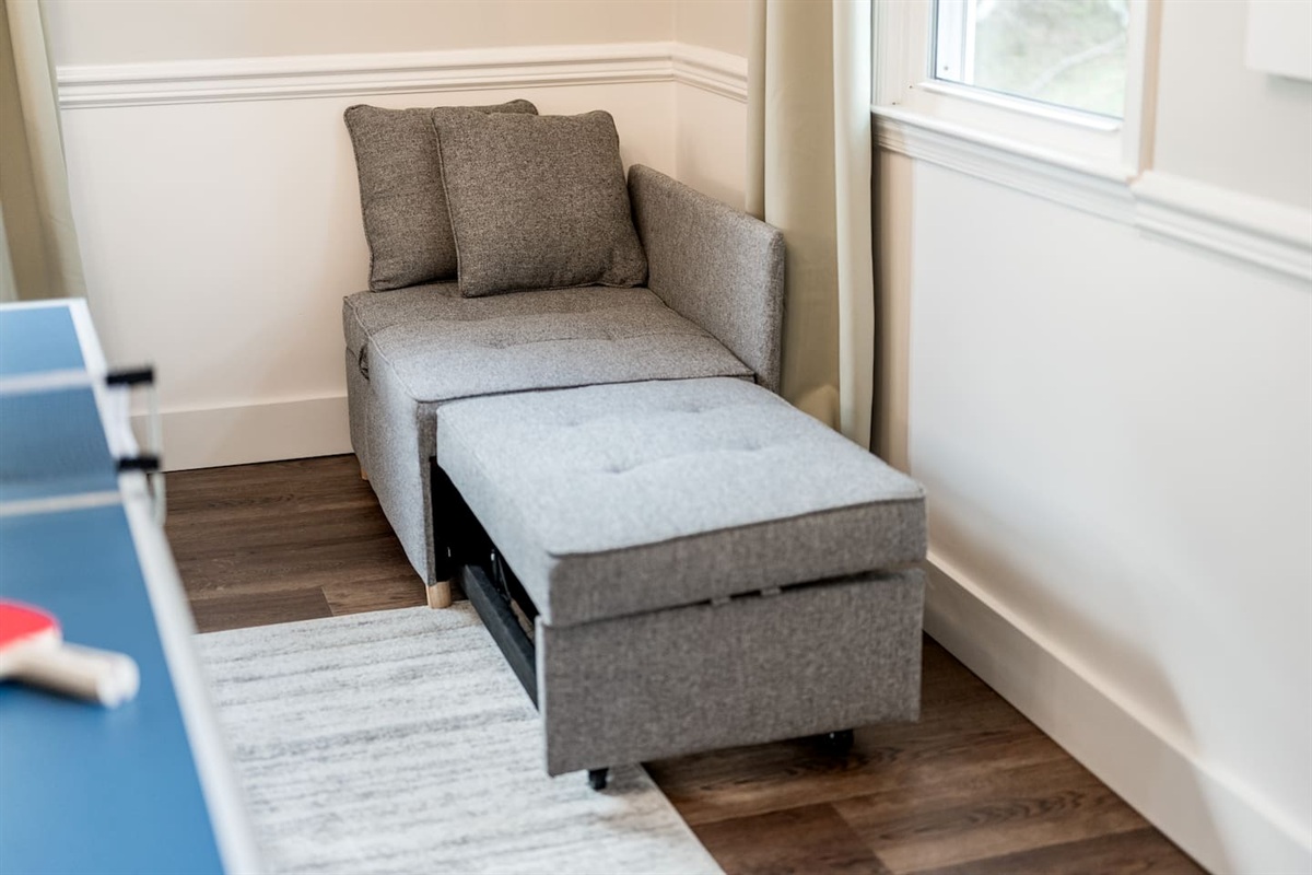 This corner chair converts into a small bed for a child.