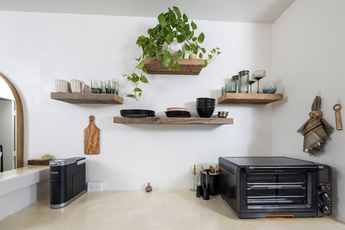 A minimalist kitchenette that makes the most of its space, featuring all the essentials for light meals and coffee breaks.