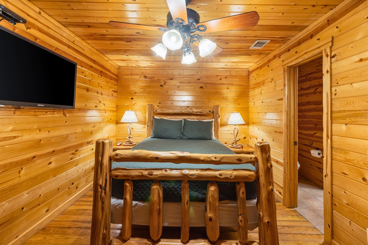 Bright wood-paneled bedroom with rustic charm.