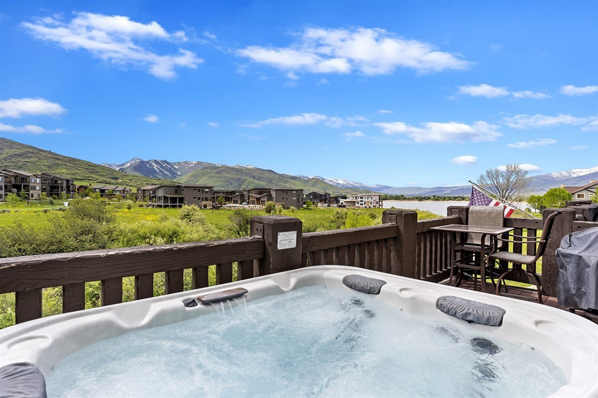 Step onto your private deck and sink into the soothing hot tub while taking in sweeping mountain vistas—an indulgent retreat designed for relaxation and unforgettable sunsets.