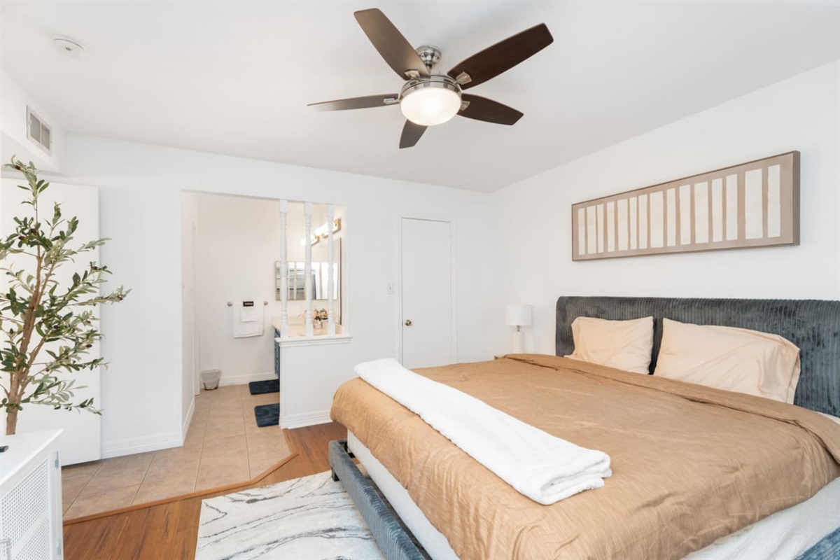 Relax in this cozy bedroom with natural light and modern decor.