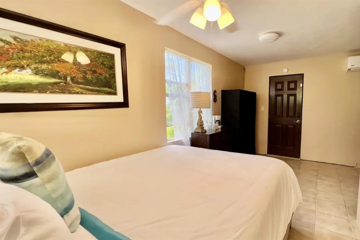 Island-inspired bedroom with cozy bedding and warm lighting—comfortable and inviting.