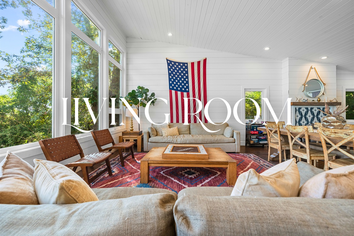 Living and dining space centered around the fireplace and big-screen TV.
