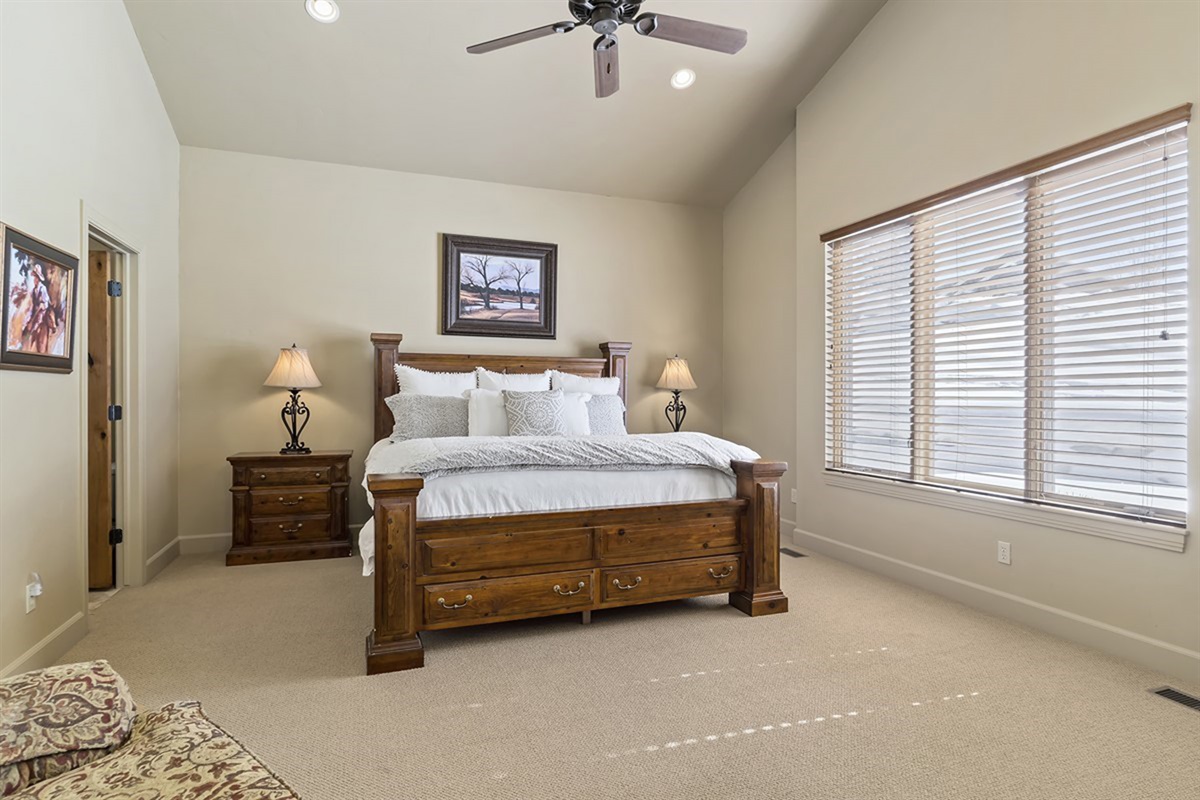 A spacious primary bedroom featuring a king bed and peaceful surroundings for a restful stay.