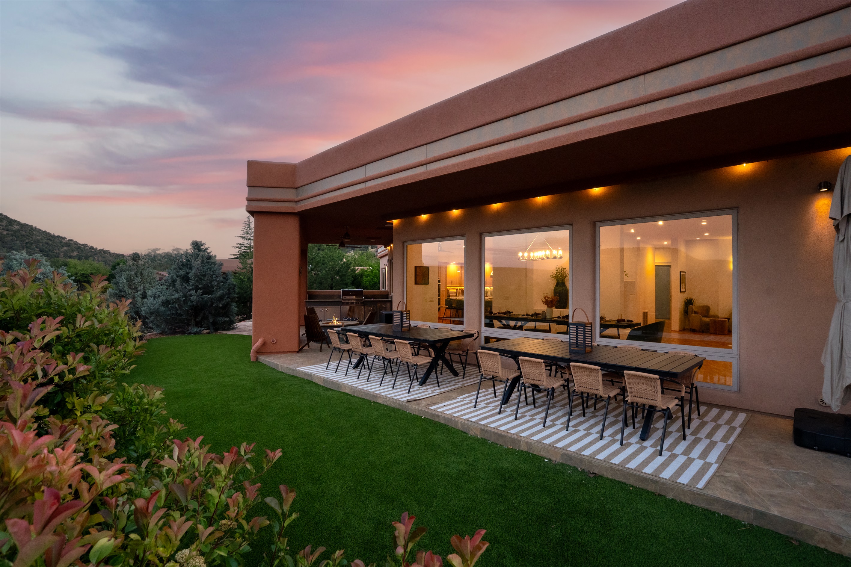 Experience luxury outdoor living. Our expansive covered patio features premium dining for 12, glowing ambient lighting, and a cozy fire pit for Sedona evenings.