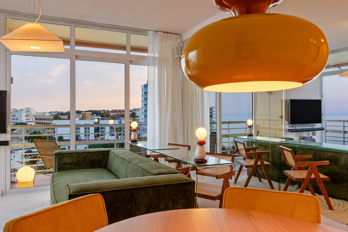 Evening ambience in the living room, with soft light and views from the corner suite.