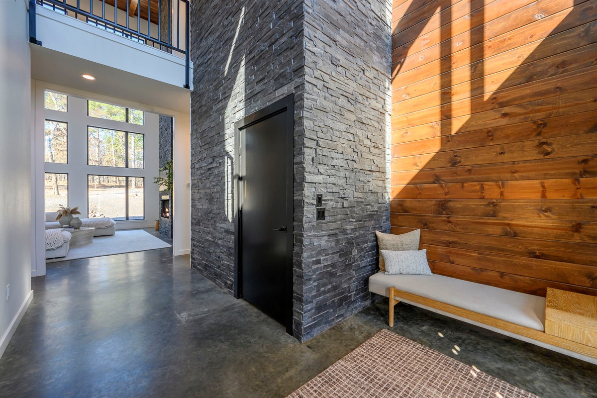 Main entrance to cabin, featuring a towering marble accent wall.