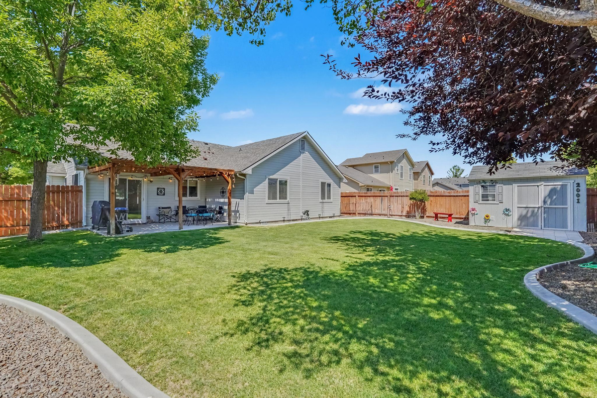 Step outside and enjoy the spacious, beautifully maintained backyard, designed for relaxation and outdoor fun. The covered patio is furnished with charming bistro lights, comfortable seating, and a BBQ grill, making it the perfect place to gather for meals