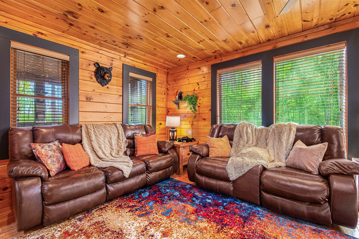 Wrapped in blankets, warmed by the fire, and watching the forest through the windows — this is what cabin dreams are made of. 🔥🍂