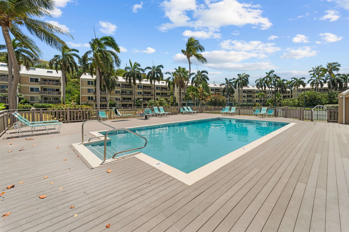 Community pool and deck with lounge chairs, just steps away from the beach!